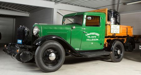 Pair of wood gas-powered Ford trucks at 